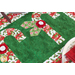 angled image of candy cane detail showing white and red fabric yo-yos and red and white candy canes on a green background