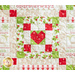 Pieced block featuring a central heart surrounded by squares and strips of red, green, and cream fabric.