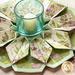 10 sided folded wreath being used as table topper with candle in the middle made of green and purple floral fabrics.