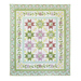 Quilt filled with sawtooth stars and flower appliqué in pastel green and purple colors.