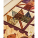 Pint Size Table Runner featuring leaf like geometric piecing and squirrel and leaf appliqué.