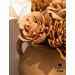 Close up of gold and white paper flowers in a clay vase.