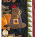 Close up of wall hanging appliqué featuring a pumpkin and a buckled hat.