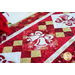 Christmas themed table runner featuring bell designs made of red and cream snowflake fabrics.