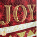 Christmas Joy Quilt Kit featuring the word Joy on red and gold fabric.