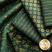 Photo of green fabric with metallic gold accents in snowflake, stripe, filigree and script motifs.