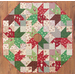Tree skirt with patchwork and geometric star design made of red, white, and green, Christmas themed fabrics.