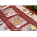 Colorful holiday table runner featuring gingerbread man, snowman, and festive decorations.