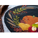 Wool placemat with appliqué of a horn filled with fruits and a pumpkin.