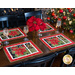 Placemats with silverware pocket made of poinsettia and green bow fabric.
