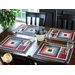 Placemats with log cabin rectangular strip design featuring a pocket for silverware and red, blue, and cream fabric prints.