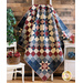 Quilt with Ohio stars in a diamond shape design made of red, white, and blue floral printed fabrics draped over furniture.