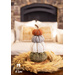 4 Flannel pumpkins stacked on top of each other resting on a table.
