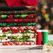 Photo of a stack of Christmas fabric with scissors and red and green thread next to it