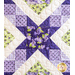 A quilt with sawtooth star design with geometric patchwork in Purple, white, and green floral fabrics.