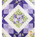 A quilt with geometric patchwork design in Purple, white, and green floral fabrics.