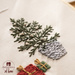 A Christmas tree in a basket hand embroidered on a fabric
