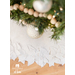 All white tree skirt with a border of layered fabric flowers and foliage.