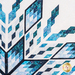 Top right quadrant of the finished quilt showing a blue geometric starburst or snowflake-like pattern on a white background