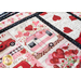 Detail of hugs, kisses, and special wishes placemats with pink and red heart motifs with a pink and white camper and black edging with small white polka dots