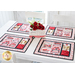 Set of 4 placemats on a white table with a camper flower pot decoration with red flowers
