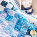 Close up of draped quilt with out of focus snowflake decoration in the background