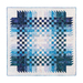 isolated image of the completed blue and white woven quilt on a white background
