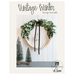 front cover of hoop wreath pattern booklet showing a completed project and evergreen tree decor against a white paneled wall above a dark countertop