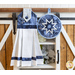 Hanging towel and round hot pad side by side hanging from a farmhouse style shelf