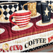 Close up image of border fabric and quilting featuring rows of steaming coffee mugs with geometric designs