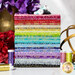 A stack of rainbow colored fabrics with silver and gold metallic embellishments.