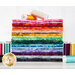 A stack of fabric in a rainbow of colors, surrounded by spools of thread.