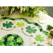 Close up of edge of table topper showing shamrocks and a scalloped border made with leaf patterned fabrics