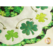 Close up of edge of table topper showing shamrocks, metallic hand embroidery details, and a scalloped border made with leaf patterned fabrics