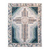 isolated image of a rectangular quilt that features a large cross motif in the center in muted floral fabrics with dark teal accents on a white background 