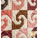 close up of a few blocks from the mini quilt featuring a swirl with opposing curved shapes from each corner in cream and differently colored patterned fabrics