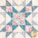 close up of one quilt block featuring a classic star pattern made with soft floral pink, blue, and cream fabrics