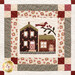 Close up of a quilt made with neutral and burgundy fabrics depicting a house with a bird perched on a branch