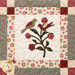 Close up of a quilt made with neutral and burgundy fabrics depicting two birds perched on a branch with flowers