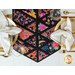 top down close up of one end of the table runner showing intersecting black fabric strips and brightly colored, stylized flowers in triangular sections with a decorative glass and gold rimmed tables with cream napkins on a white table