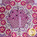 close up of the center of the quilted flower design on the top of the pincushion with floral fabrics and a purple tree fabric in the center.
