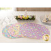 Set of four pastel, Easter themed placemats fanned out across a white tabletop with clear glasses, a stack of plates, and a colorful egg centerpiece positioned in front of a bright window and brown paneled wall.