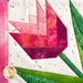 Close up of detail stitching in quilt block featuring a pink tulip with green leaves