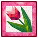 Finished quilt block featuring a pink tulip with green leaves bordered by pink mottled fabrics isolated on a white background