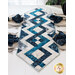 Blue and cream table runner with a criss crossing diamond pattern from end to end with pointed ends on a white wood table with four place settings with matching blue napkins and a white paneled wall with a bright window and houseplant in the background