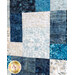 Close up of blue and cream batik squares with elaborate quilting designs overtop