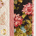 Close up photo of the border of the Diamonds and Stars Quilt showing black and cream floral fabrics with pink sashing and binding.