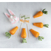 Fabric carrots and the back end of a white bunny with a sign that says 