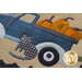 A close up the embroidery stitching, wool cat, vintage truck, and pumpkins 