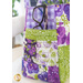 Close up of outside pocket on one side of the tote bag made with purple and green floral fabrics with a pair of black framed glasses